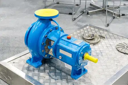 Industrial pump volute in blue casing displayed on metal surface for mechanical system demonstration